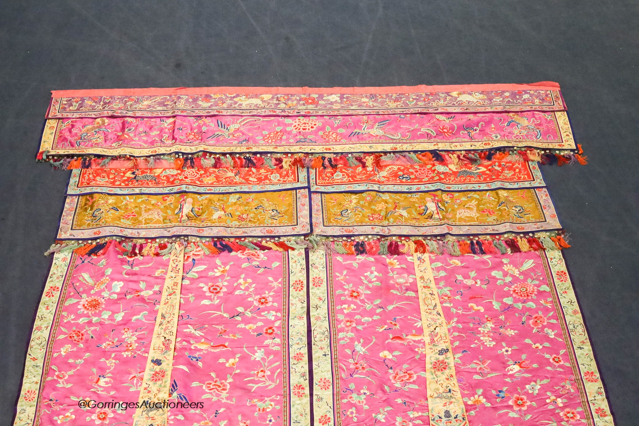 A pair of 20th century Chinese silk embroidered ceremonial panels, possibly for a wedding, 228cm not including fringing, each panel width 80cm, with a matching pelmet, width 198cm